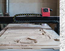 CNC router bed after routing a wood panel
