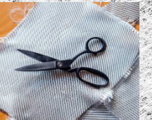Trimming a fibreglass sheet with scissors on the workbench