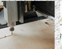 CNC router cutting a timber sheet, dust clearing