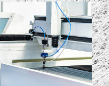 CNC router with coolant line cutting a sheet panel