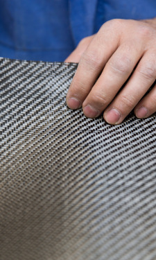 Hand checking the twill weave on a carbon fibre sheet
