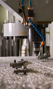 CNC spindle positioned over a mounted metal workpiece